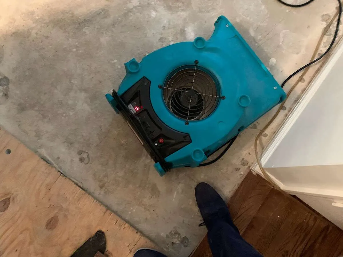 Air mover drying subfloor during Commercial Water Damage Restoration in Anchorage